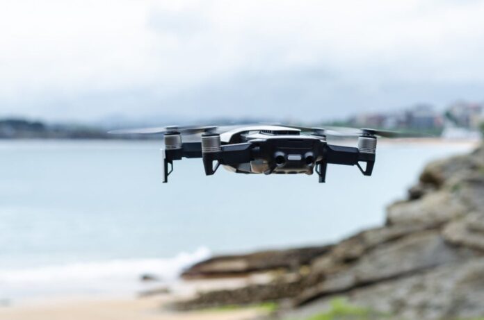 modern drone flying rocky seacoast 1019x675.jpg